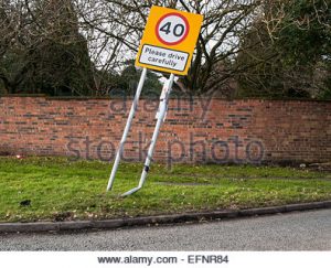 Leaning road sign